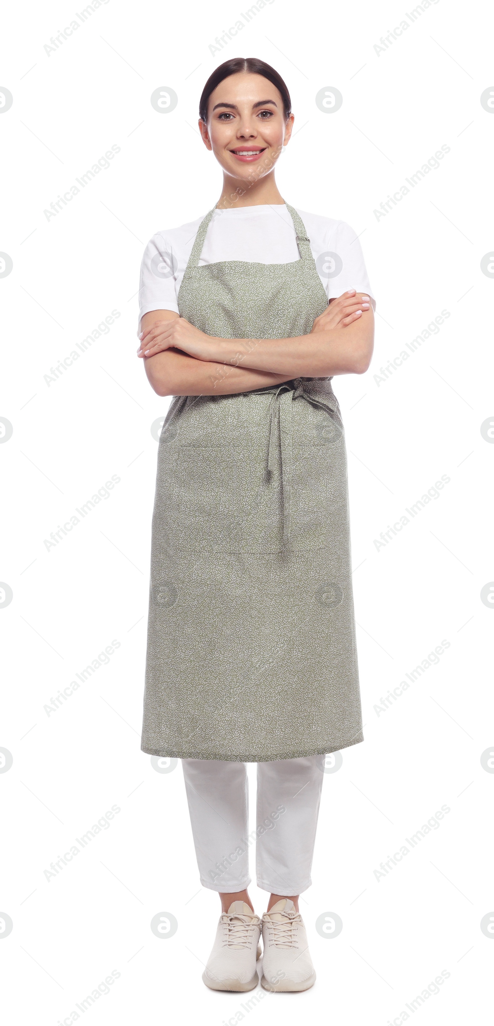 Photo of Young woman in light green apron on white background