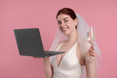 Photo of Happy bride with laptop on pink background