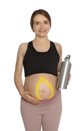 Sporty pregnant woman with kinesio tapes holding water bottle on white background