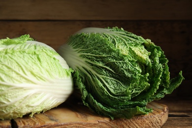 Photo of Fresh ripe Chinese cabbages on wooden table, closeup