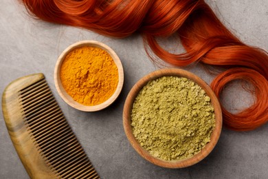 Photo of Flat lay composition with henna and turmeric powder on light grey table. Natural hair coloring