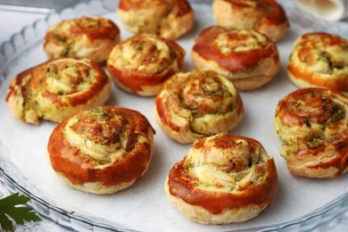 Fresh delicious puff pastry with tasty filling on tray, closeup