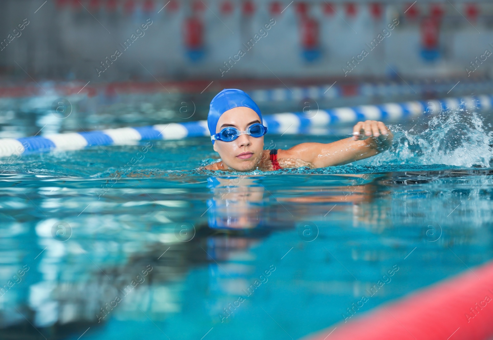 Photo of Young athletic woman swimming in pool