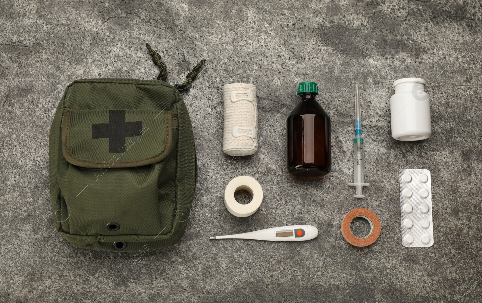 Photo of First aid kit on grey table, flat lay