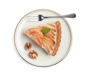 Delicious apple pie with fork and walnuts on white background, top view