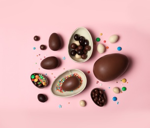 Photo of Flat lay composition with chocolate Easter eggs on color background