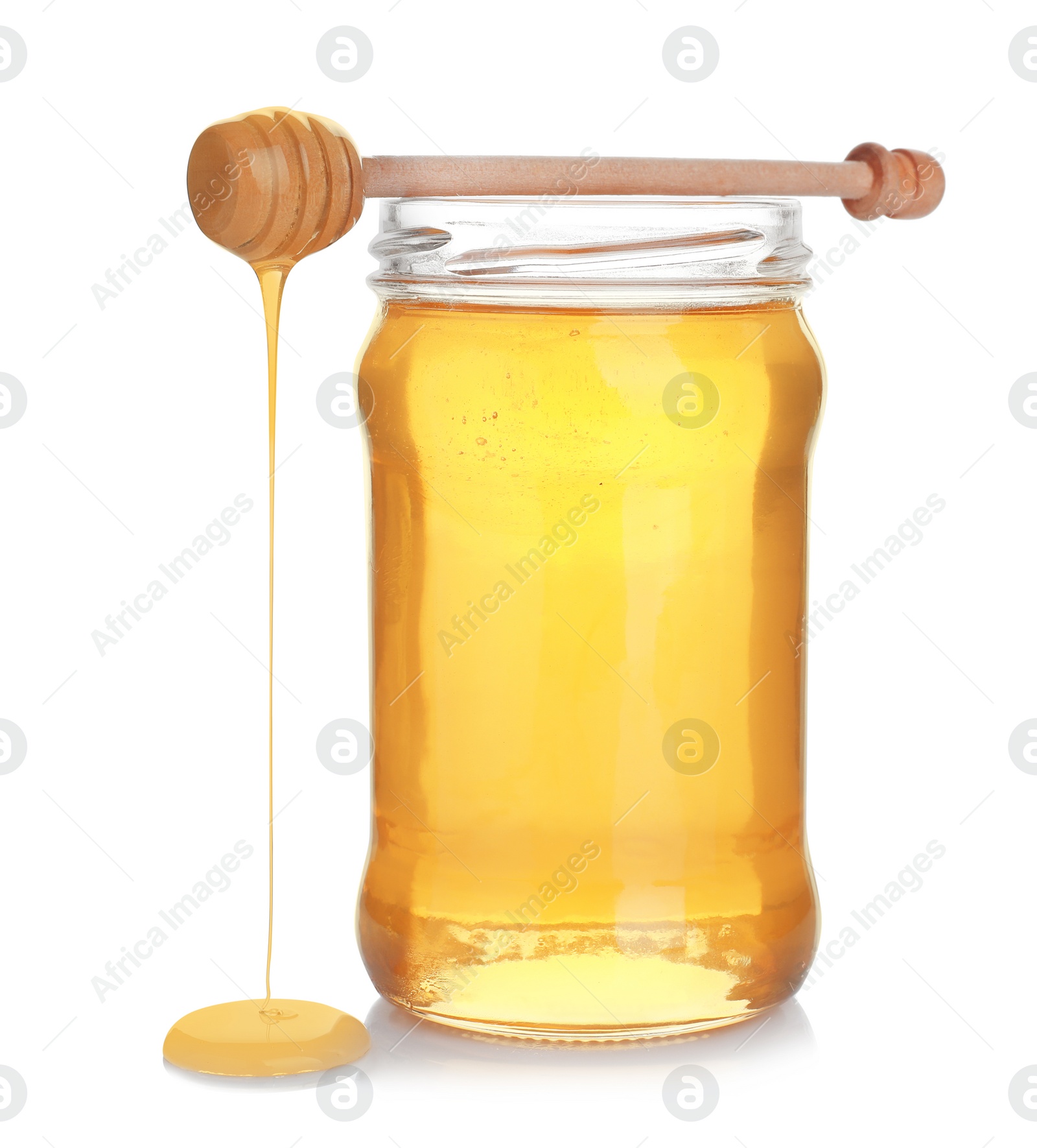 Photo of Jar of organic honey and dipper isolated on white