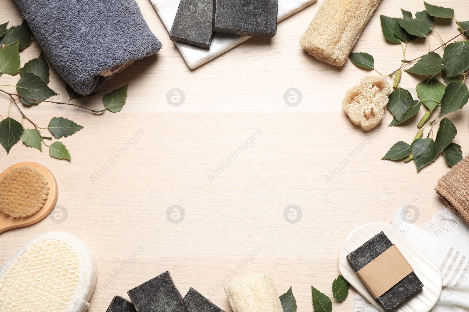 Photo of Flat lay composition with natural tar soap on wooden table. Space for text