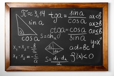 Photo of Chalkboard with many different math formulas on white wall