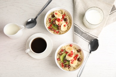 Flat lay composition with quinoa porridge and coffee on wooden background. Tasty breakfast