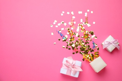 Photo of Boxes and bright confetti on pink background, flat lay. Space for text