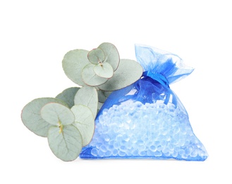 Photo of Scented sachet with aroma beads and eucalyptus branches on white background