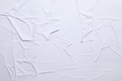 White crumpled sheet of paper as background, top view. Wall poster