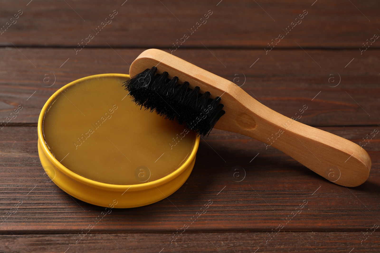 Photo of Shoe care accessories on wooden background, closeup