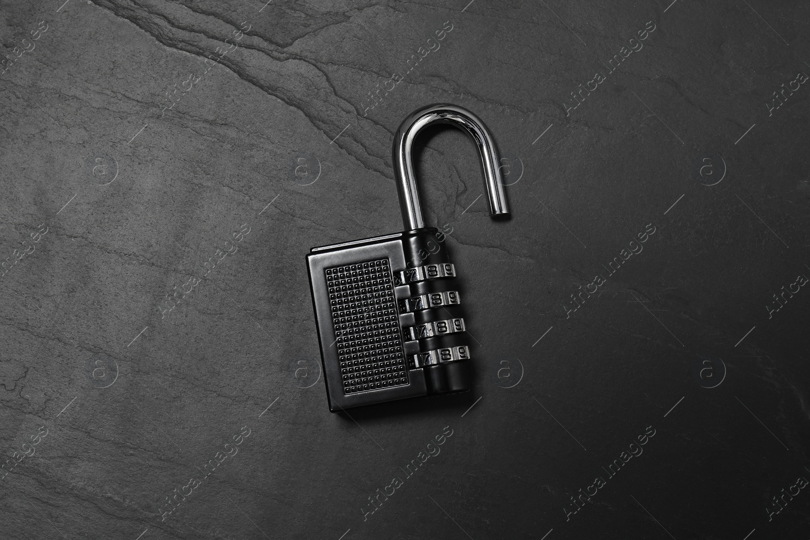 Photo of One steel combination padlock on black table, top view