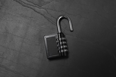 One steel combination padlock on black table, top view