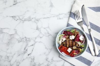 Photo of Delicious salad with roasted eggplant, feta cheese and chia seeds served on white marble table, flat lay. Space for text