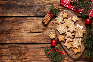 Photo of Flat lay composition with tasty Christmas cookies on wooden table. Space for text