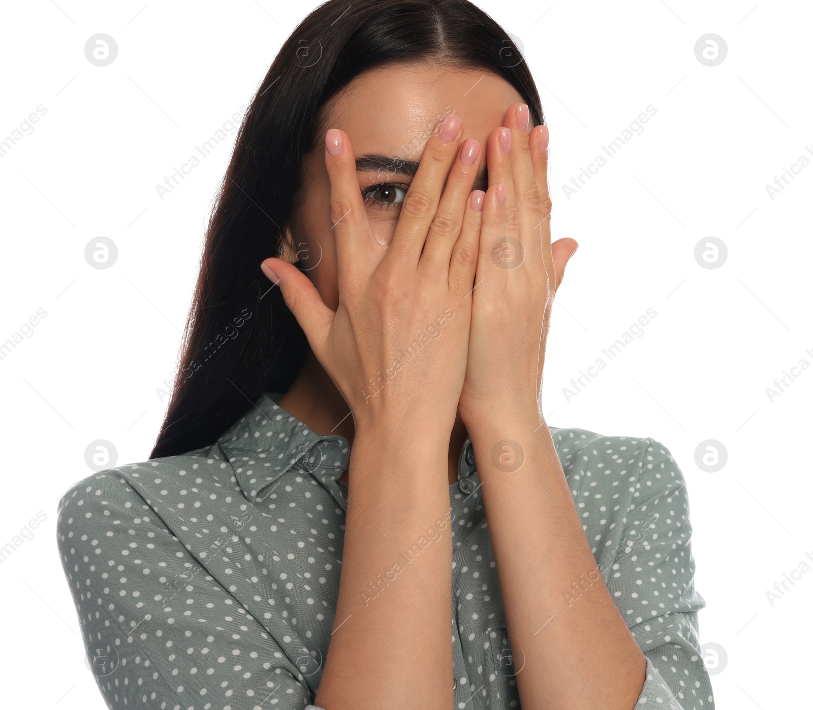 Photo of Embarrassed young woman covering face with hands on white background