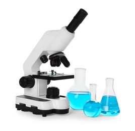 Laboratory glassware with light blue liquid and microscope isolated on white