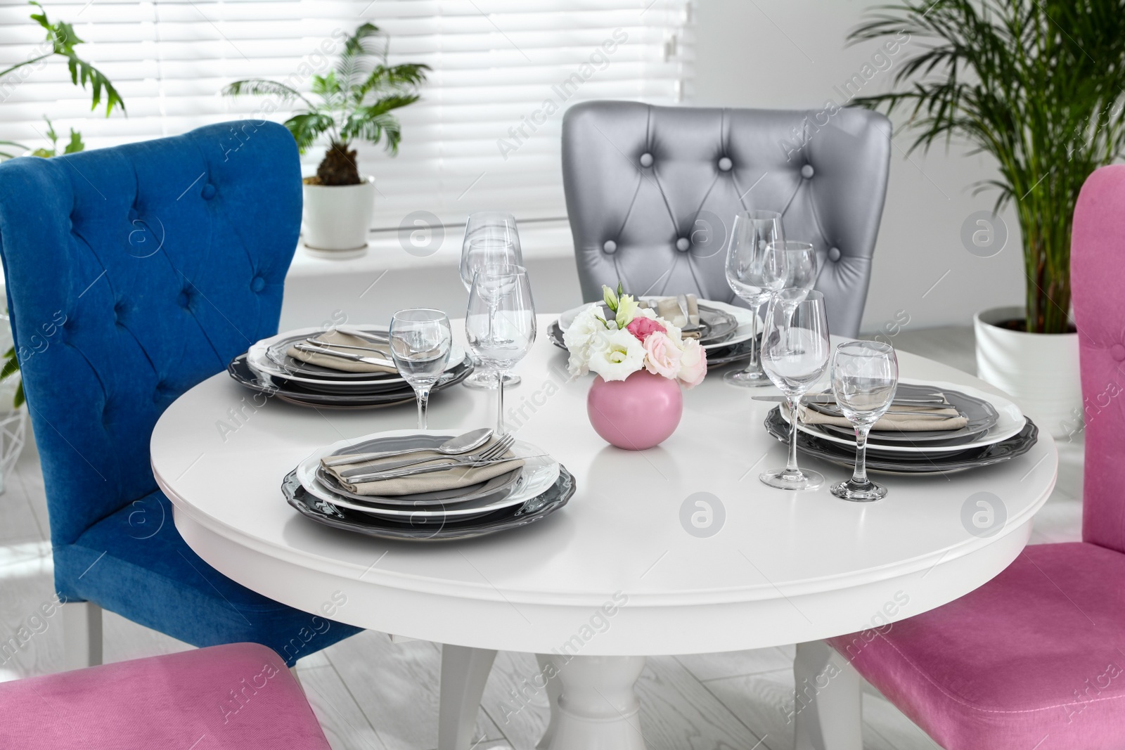 Photo of Elegant dining room interior with stylish chairs and table