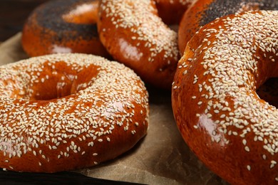 Photo of Different delicious fresh bagels on table, closeup