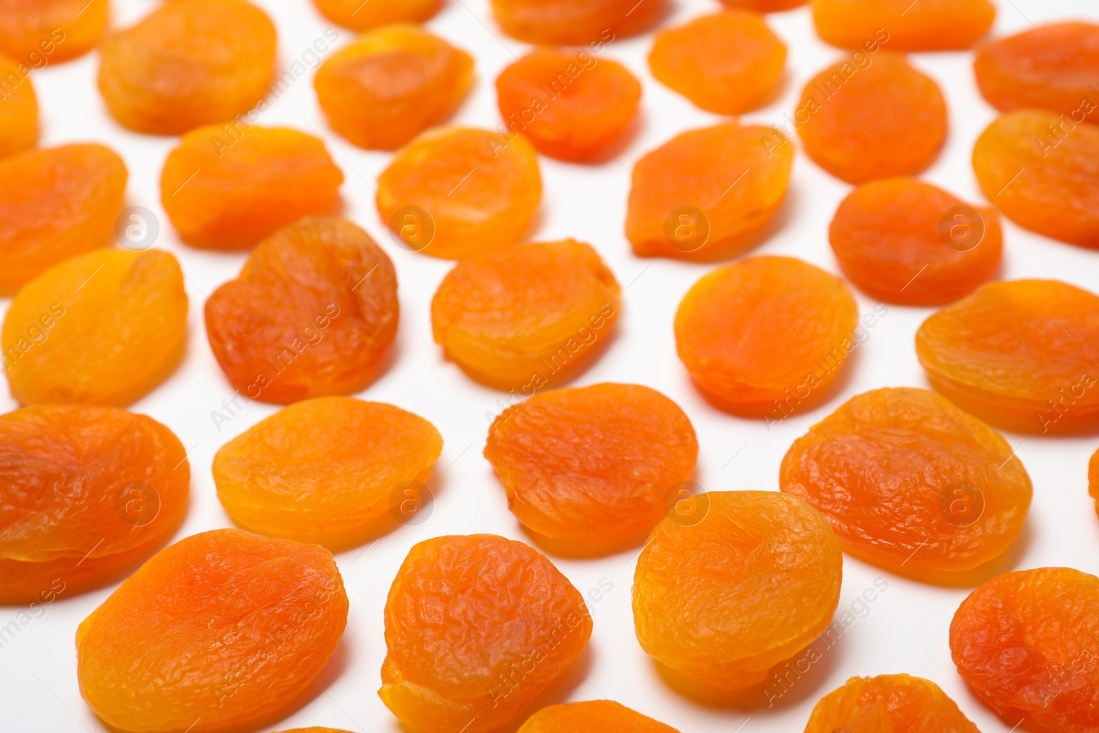 Photo of Dried apricots on white background. Healthy fruit