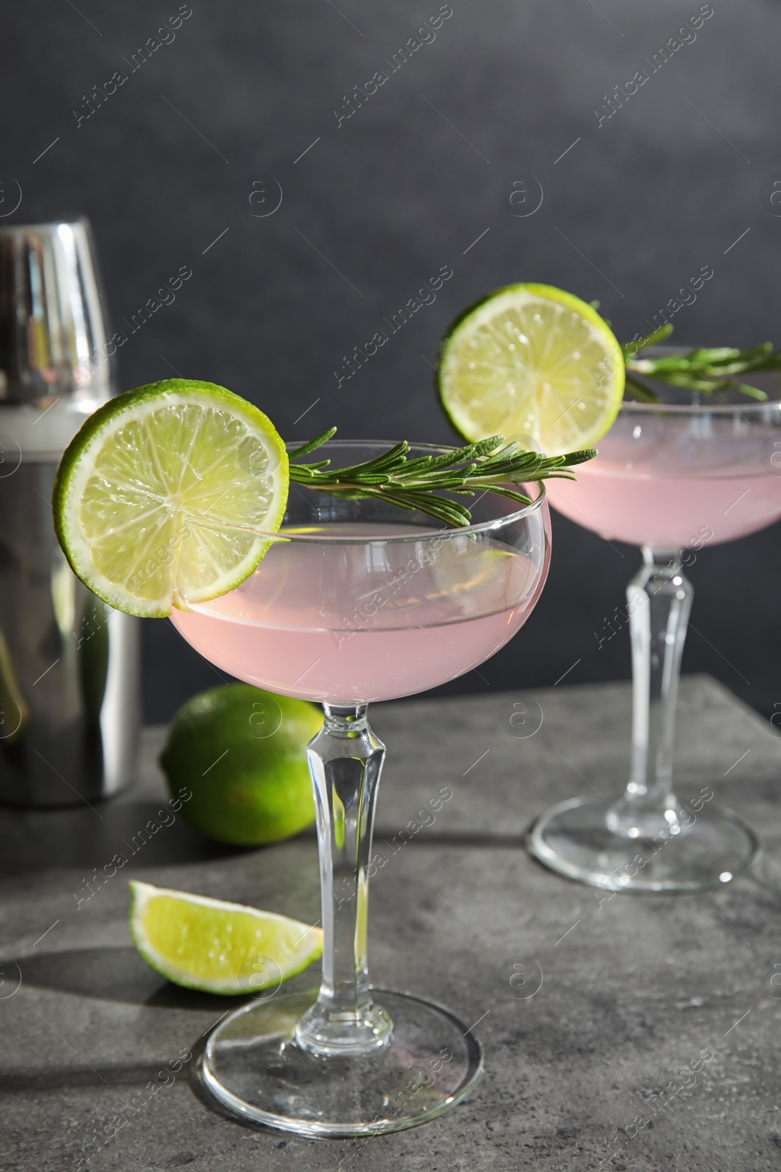Photo of Tasty refreshing lime cocktail with rosemary on table