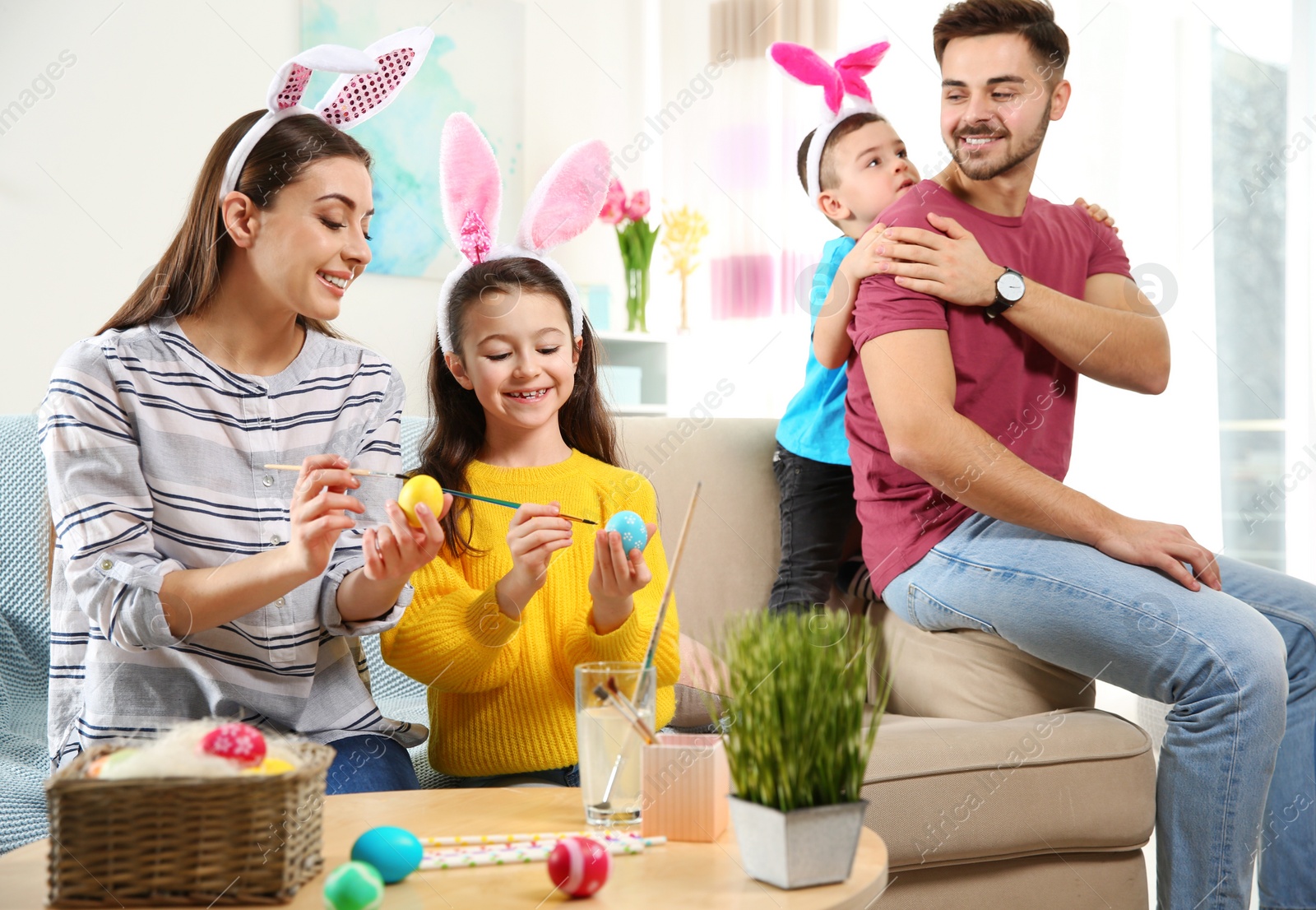 Photo of Happy family preparing for Easter holiday at home