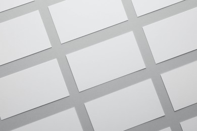 Photo of Blank business cards on light gray background, flat lay. Mockup for design