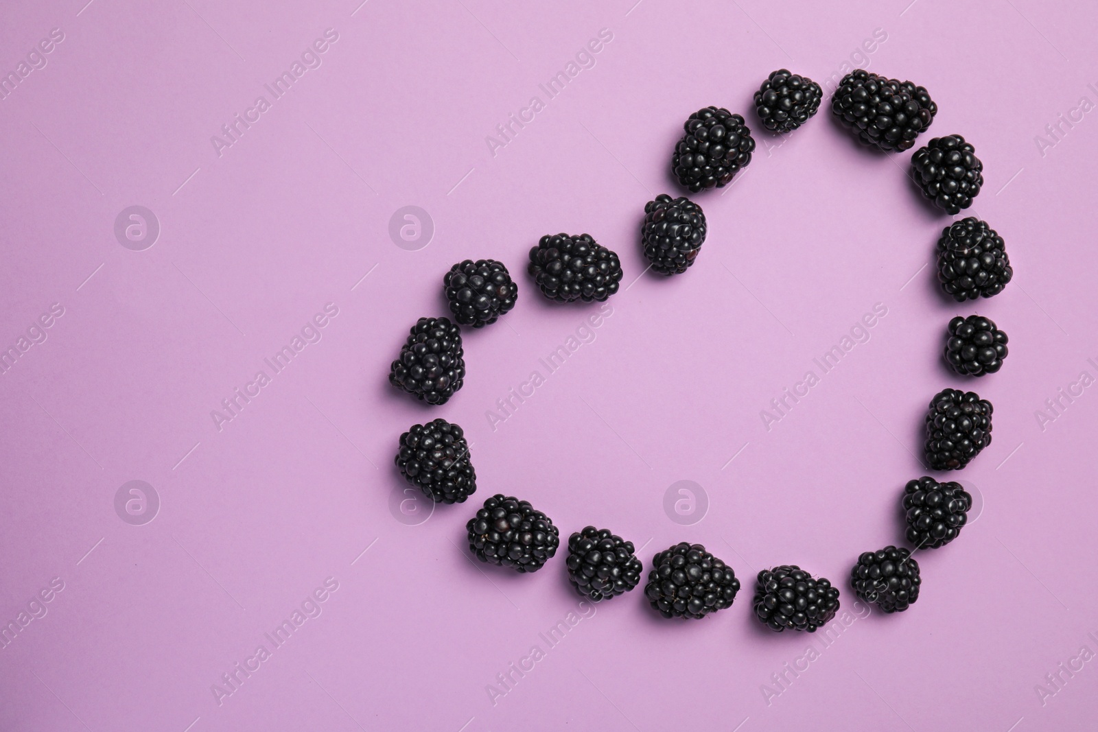 Photo of Flat lay composition with ripe blackberries on color background