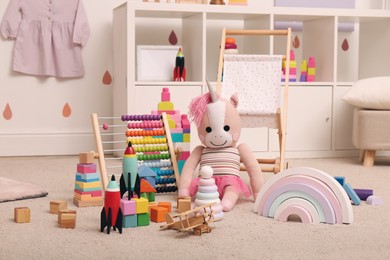 Many different toys on floor in child's room