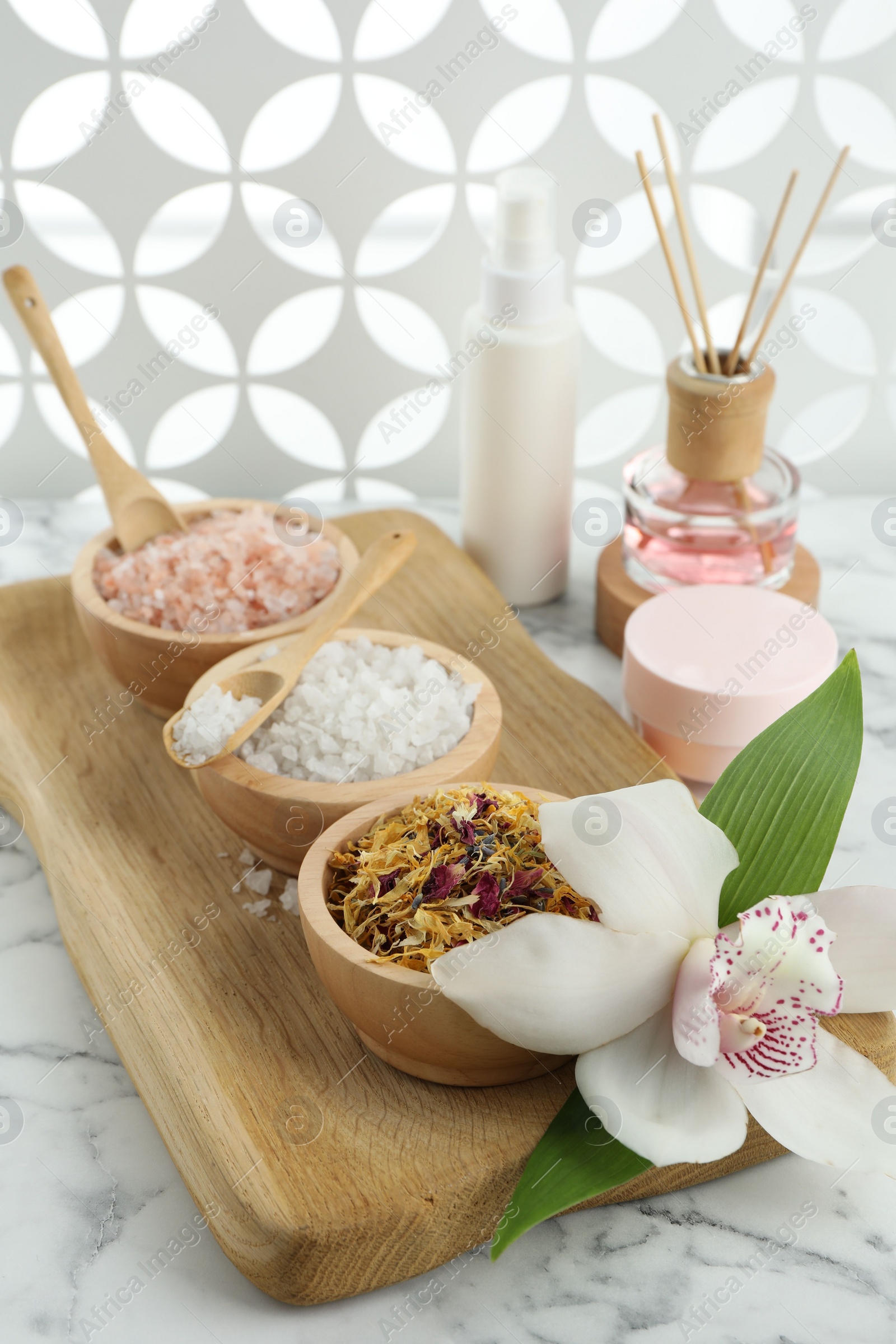 Photo of Beautiful composition with different spa products and orchid on white marble table