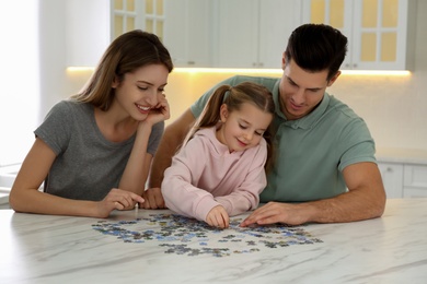 Happy family playing with puzzles at home