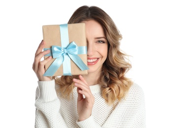 Beautiful young woman with Christmas present on white background