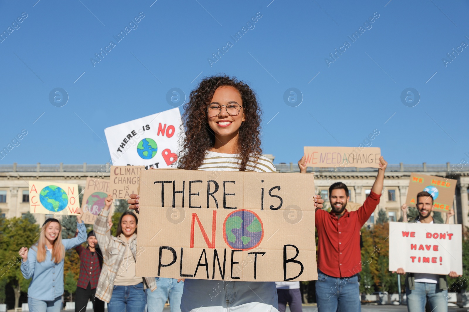 Photo of Group of people with posters protesting against climate change outdoors