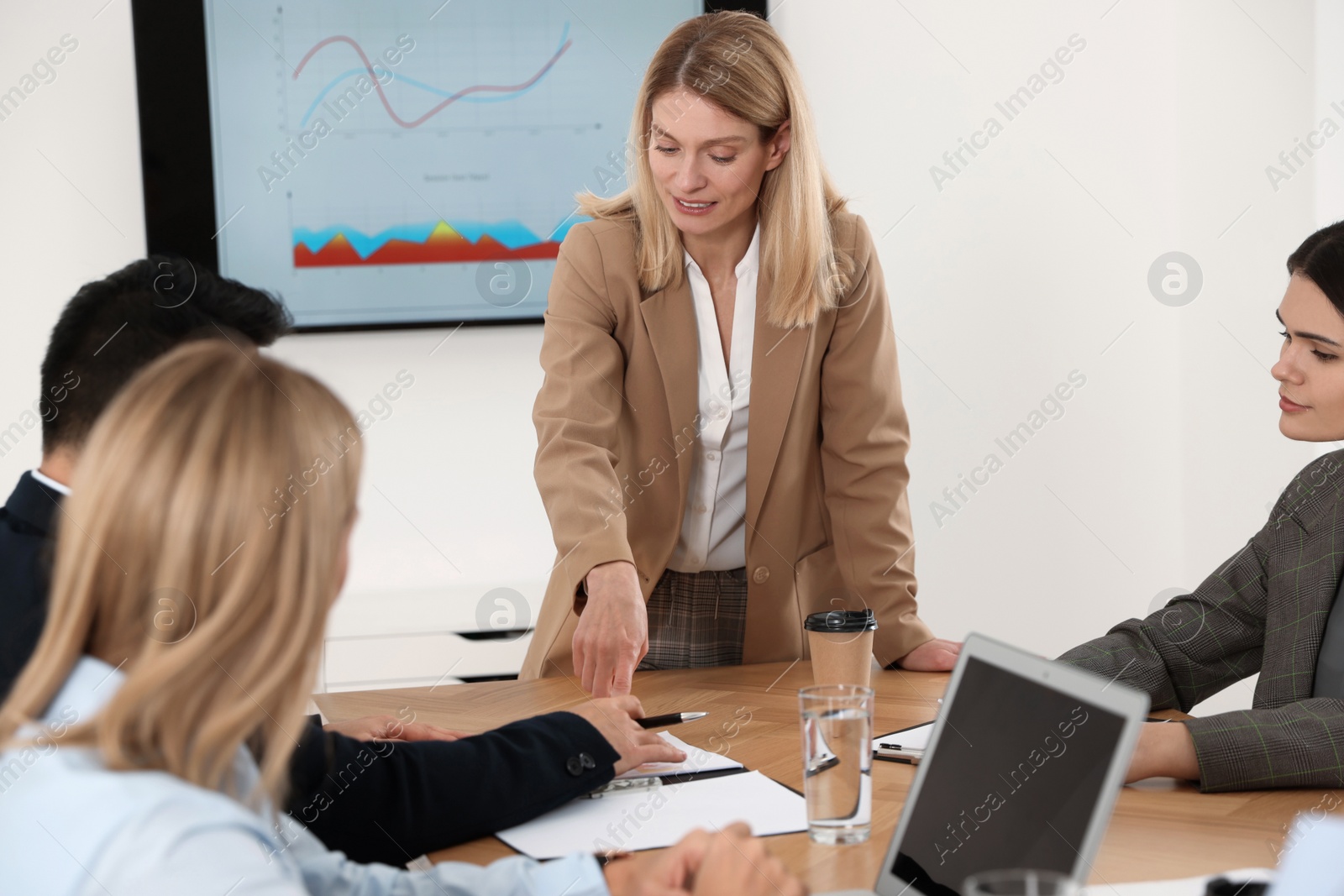 Photo of Businesswoman having meeting with her employees in office