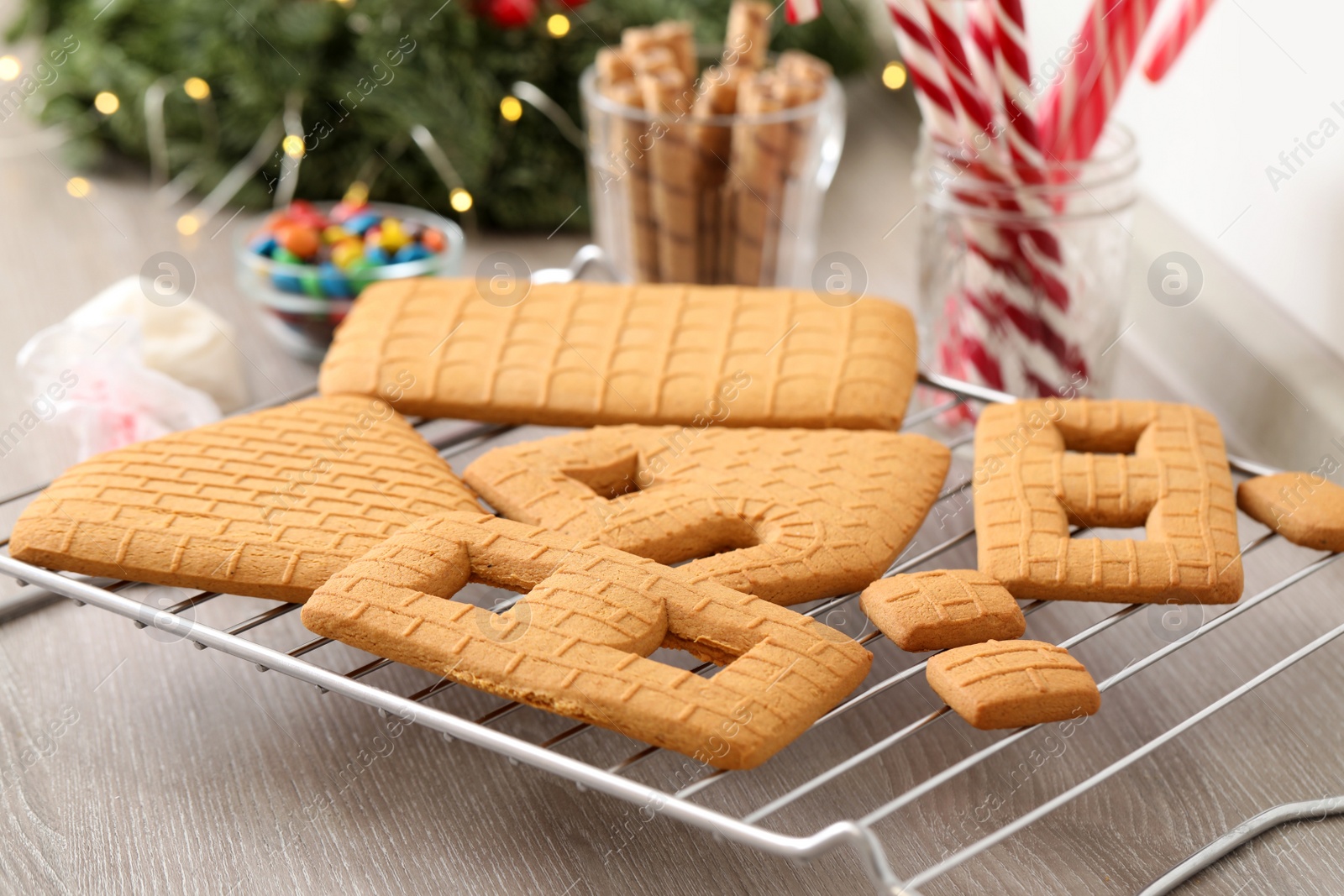 Photo of Parts of gingerbread house on wooden table, closeup