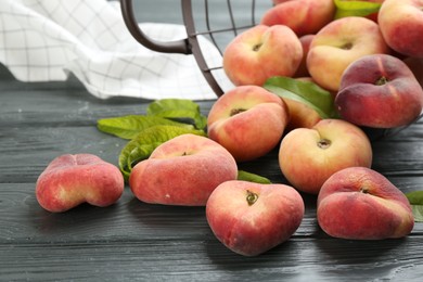 Fresh ripe donut peaches on grey wooden table