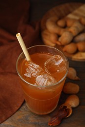 Photo of Freshly made tamarind juice and fresh fruits on wooden table, above view