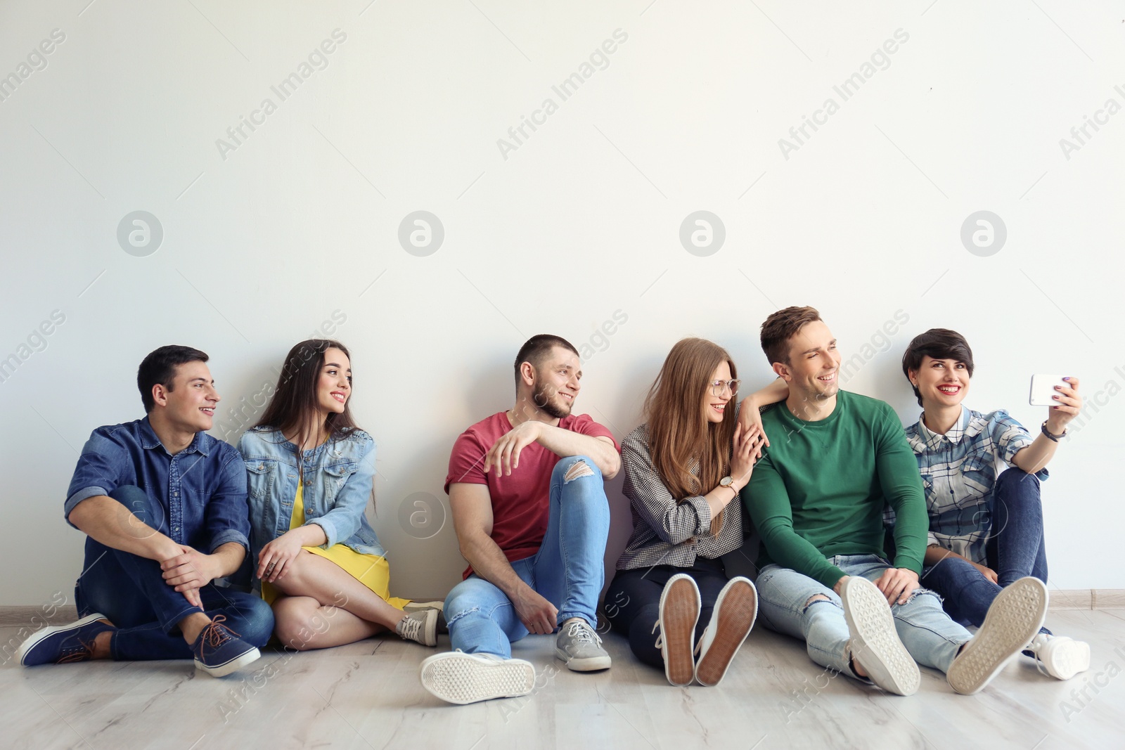 Photo of Happy friends taking selfie indoors