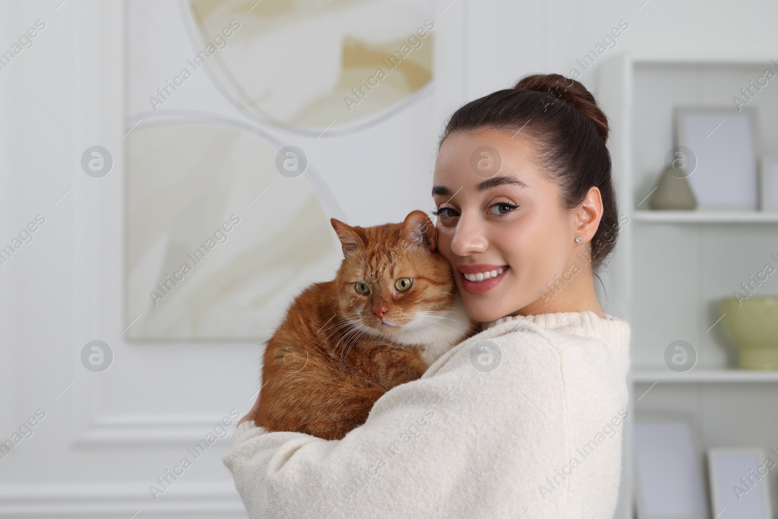 Photo of Beautiful woman with cute cat at home