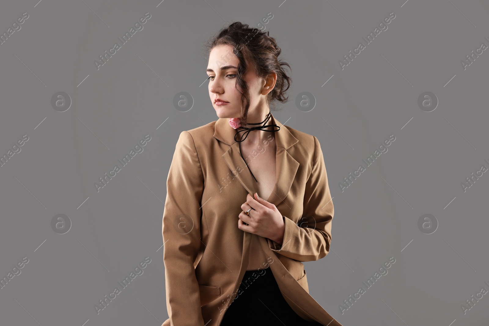 Photo of Portrait of beautiful young woman on grey background