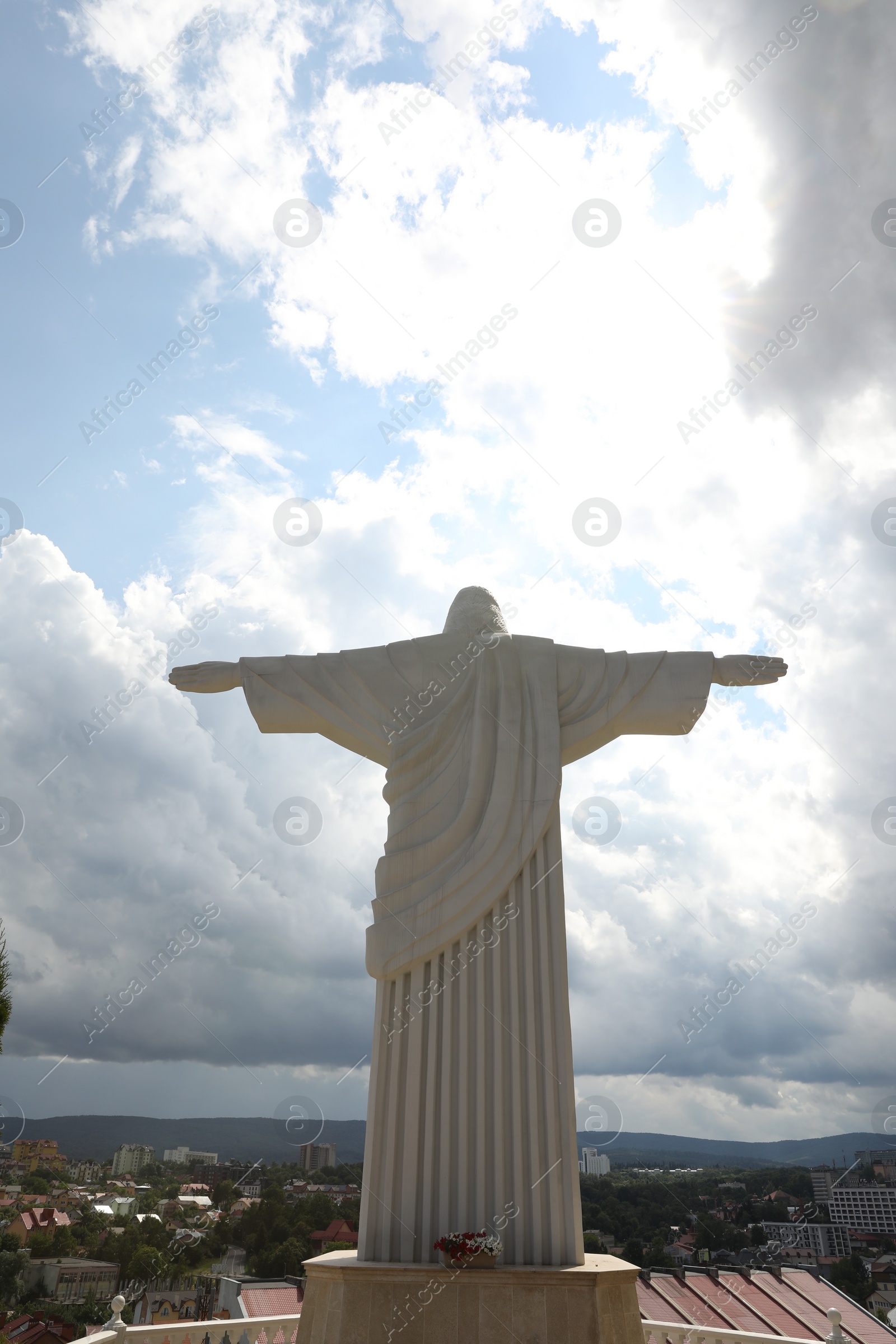 Photo of Truskavets, Ukraine - July 22, 2023: Statue of Christ the Redeemer against beautiful cityscape, space for text