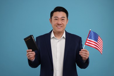Photo of Immigration. Happy man with passport and American flag on light blue background