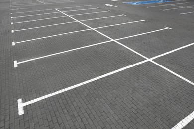 Photo of Empty car parking lots with white marking lines outdoors