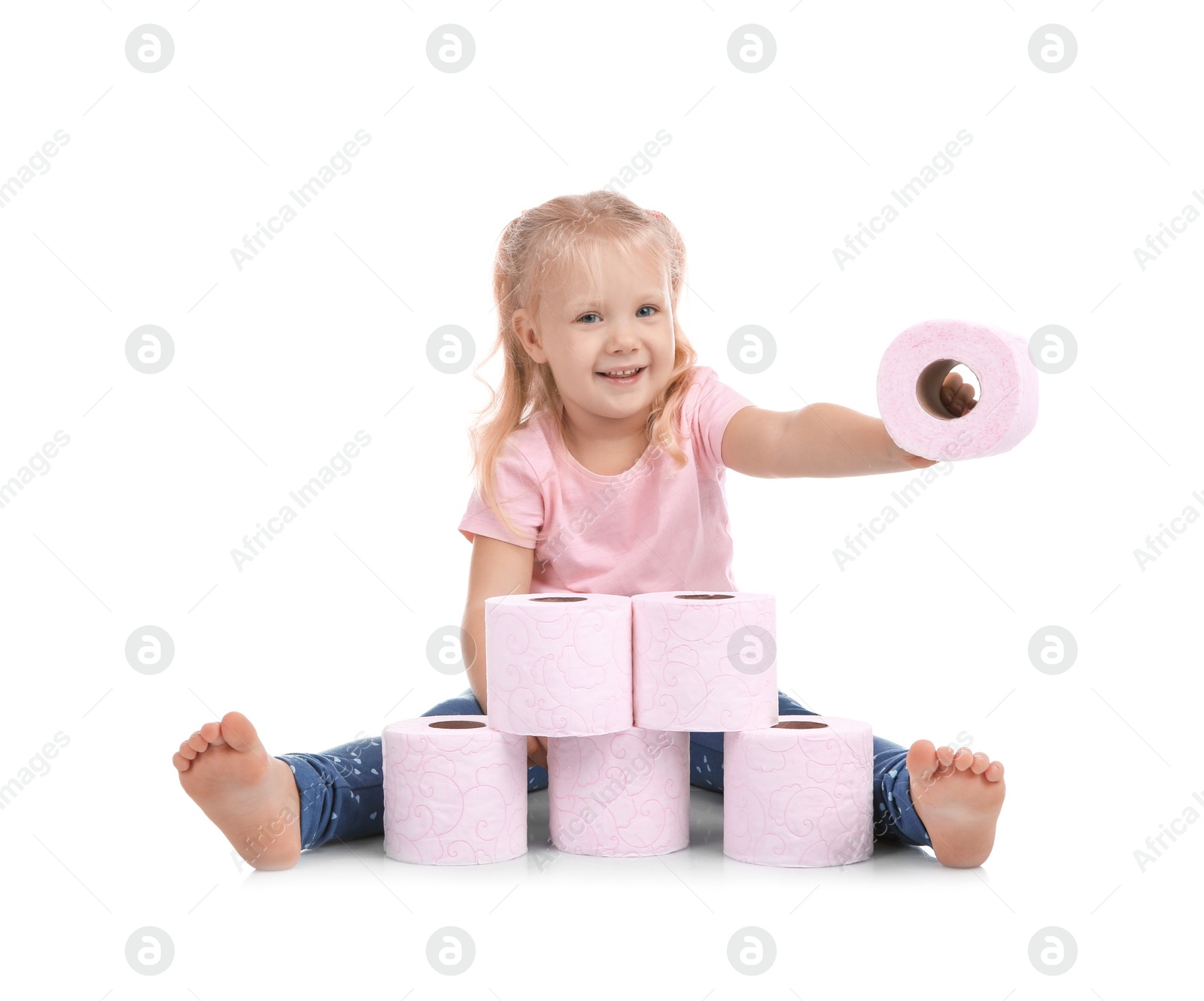Photo of Cute little girl making toilet paper pyramid on white background
