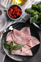 Tasty ham with basil, pickled peppers and carving fork on table, flat lay