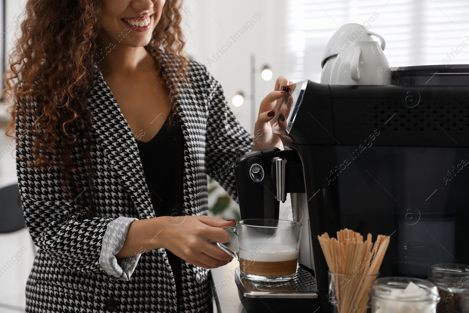 Photo of African American woman preparing fresh aromatic coffee with modern machine in office, closeup