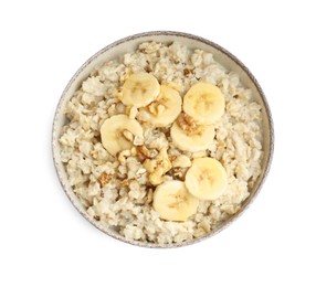 Photo of Tasty oatmeal with banana and walnuts in bowl isolated on white, top view